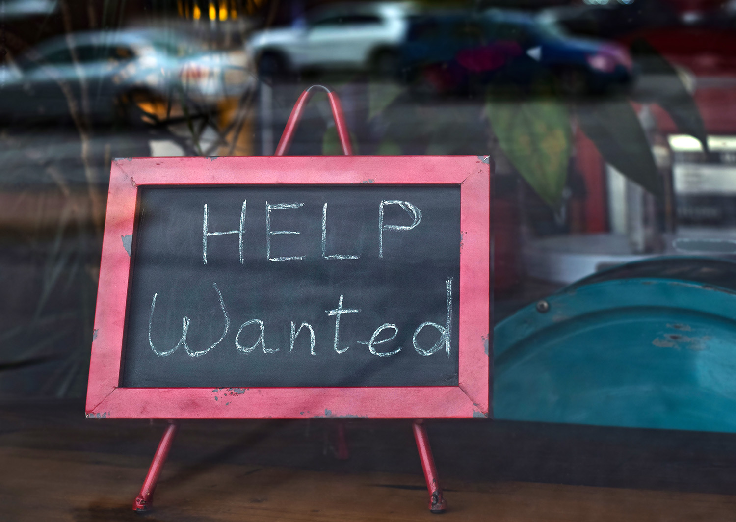 "Help wanted" sign inside a business window.