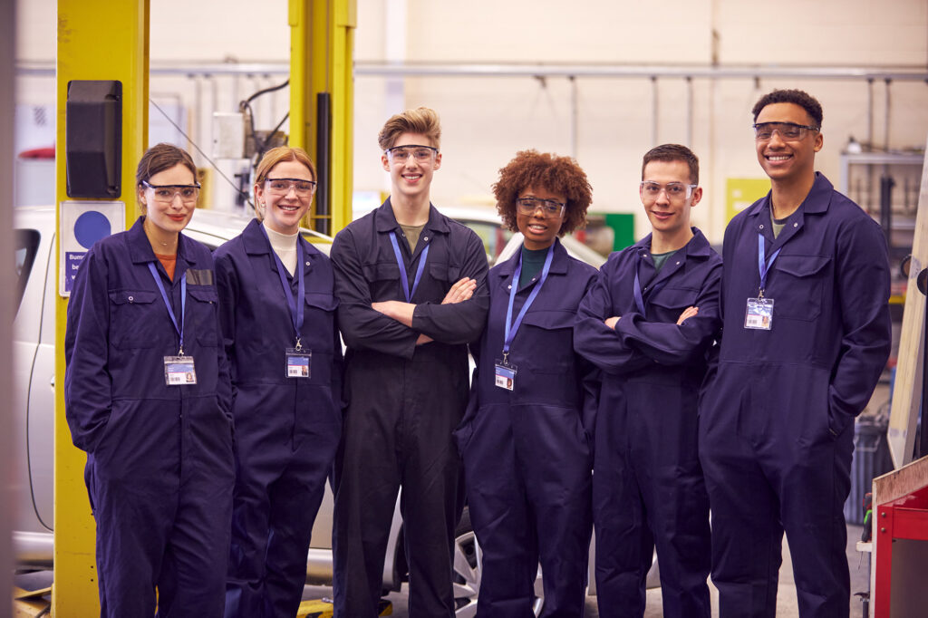Group of young apprentices in an auto repair shop